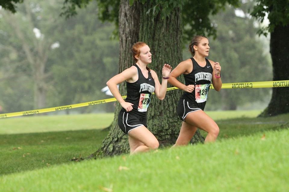 PHS girls cross country runners competing at a meet