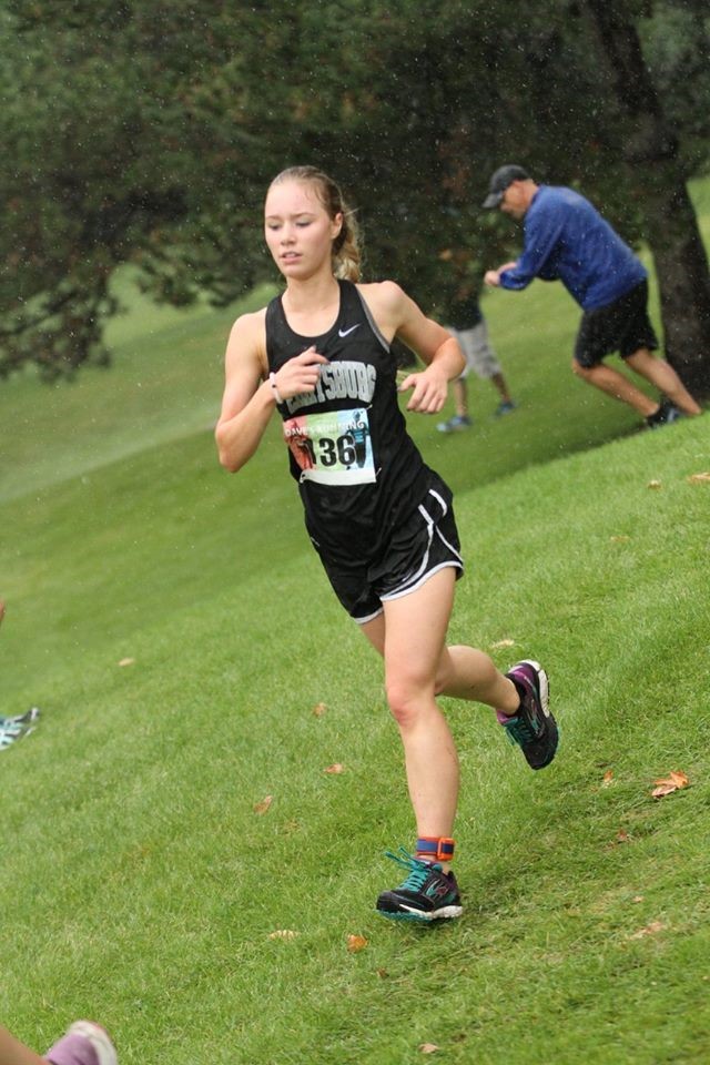 PHS girls cross country runner competing at a meet