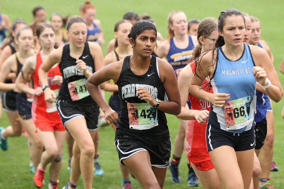 PHS girls cross country runners competing at a meet