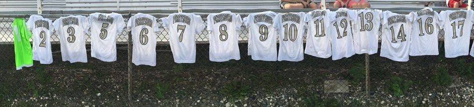 PHS soccer jerseys hung on a fence during warmups