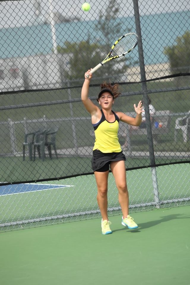 PHS student athlete hitting a tennis ball