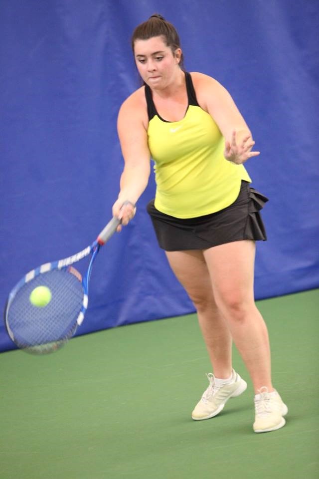PHS student athlete hitting a tennis ball