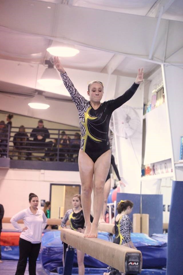 PHS student athlete performing on beam