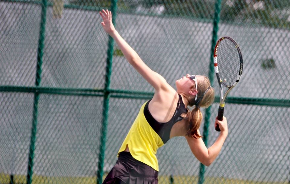 PHS student athlete hitting a tennis ball 