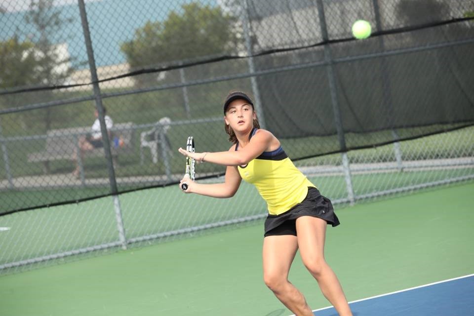 PHS student athlete hitting a tennis ball 