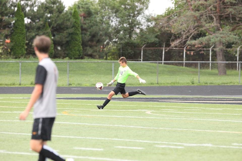 PHS soccer player kicking a soccer ball