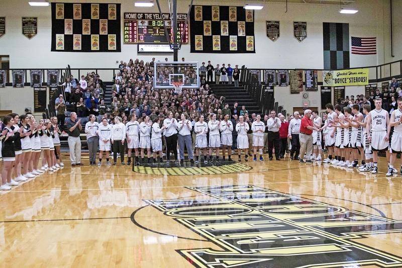 PHS basketball team and students standing for the national anthem