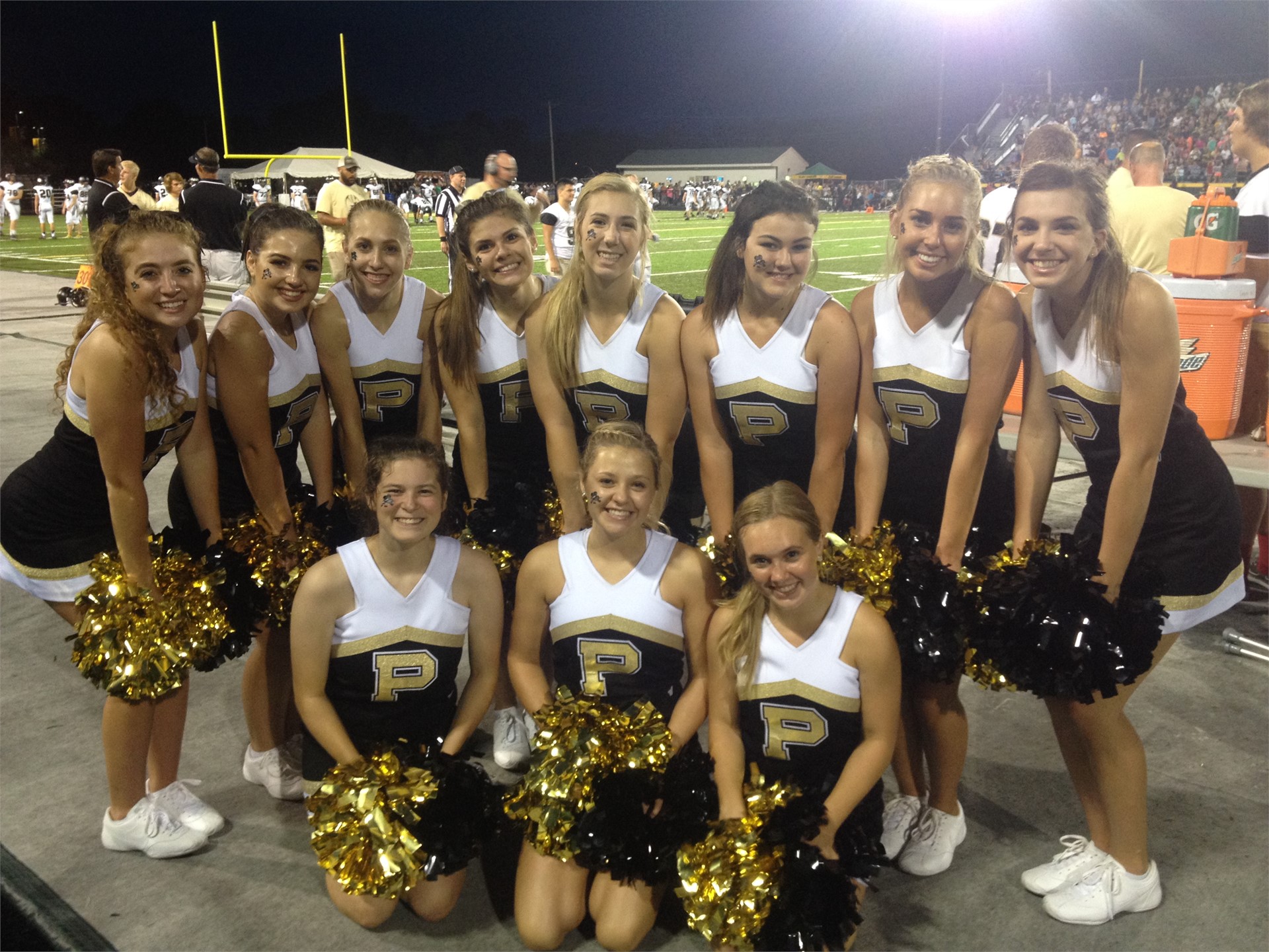 PHS cheerleaders posing at a football game