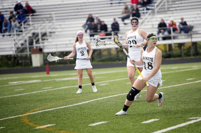 Lacrosse Player running with the ball