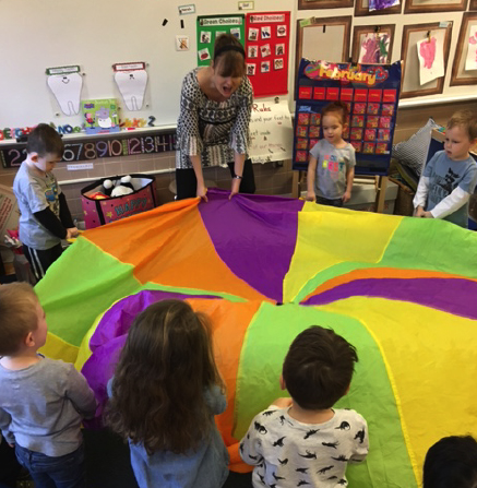 Preschool class with colorful parachute