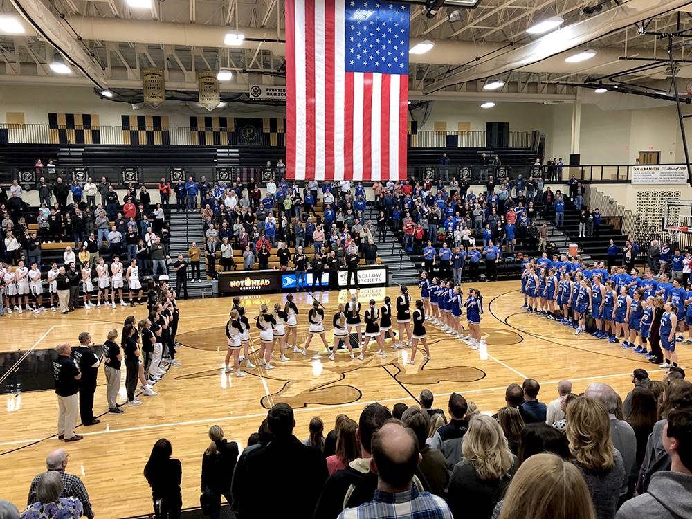 Military appreciate night at basketball game - entire gym standing and saluting the flag