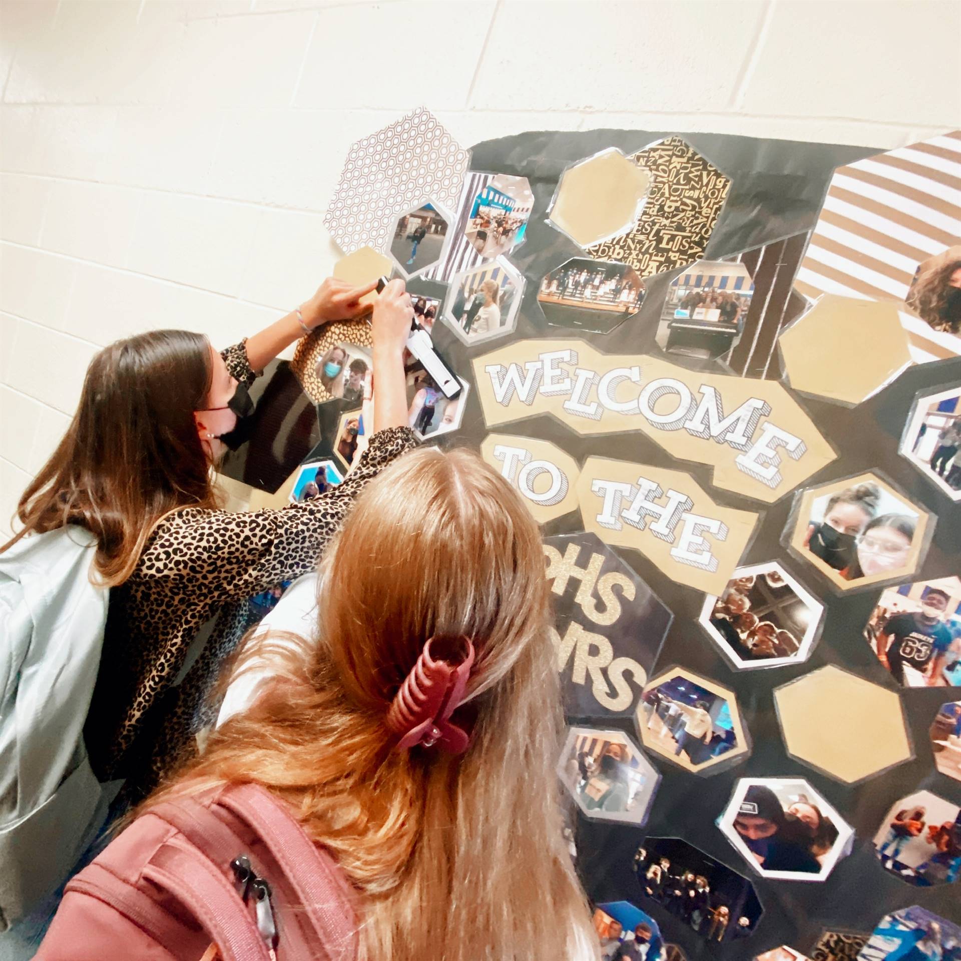 Choir president, Molly Boros, decorates the welcome bulletin board with help from Lauren Rogers
