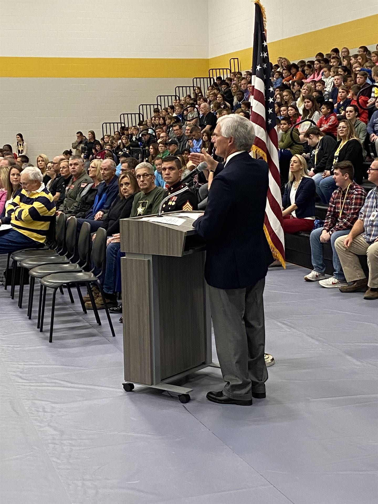 Large assembly with a person at the podium