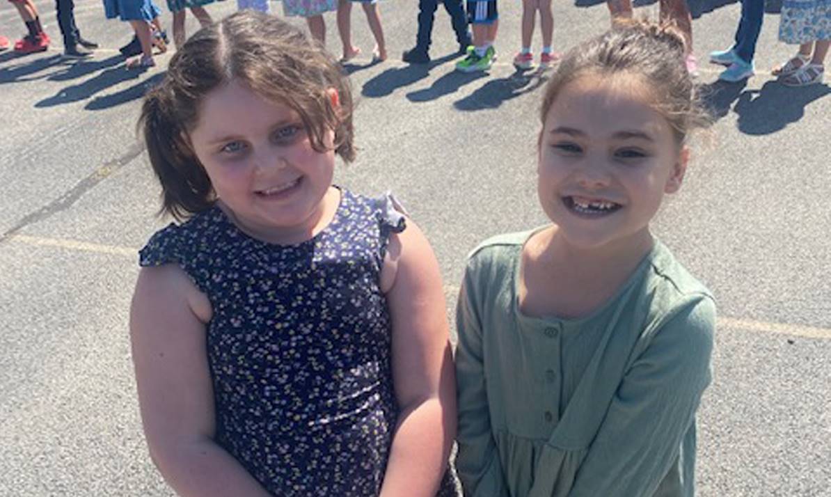 two girls smiling on the playground