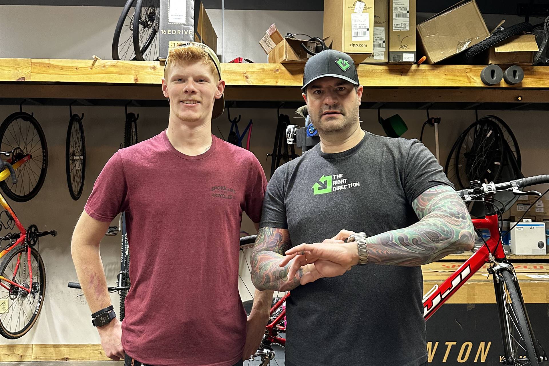 Two people in a bicycle repair shop