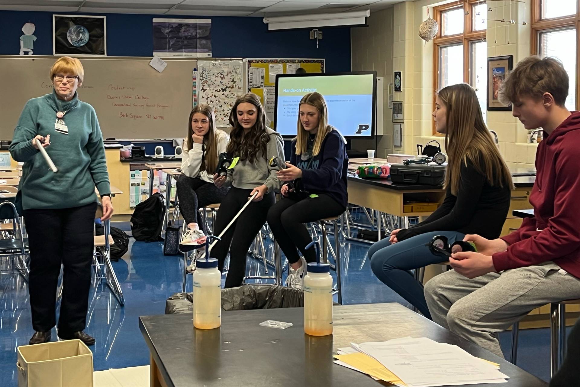 Six people in a classroom