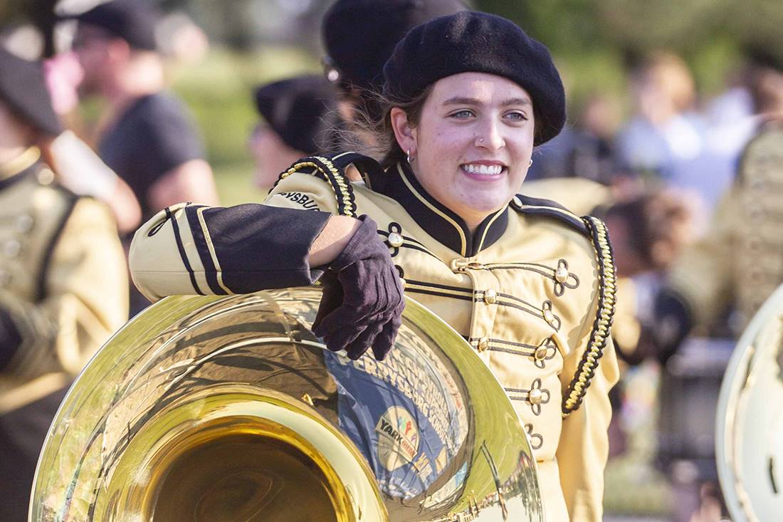 student smiling with tuba