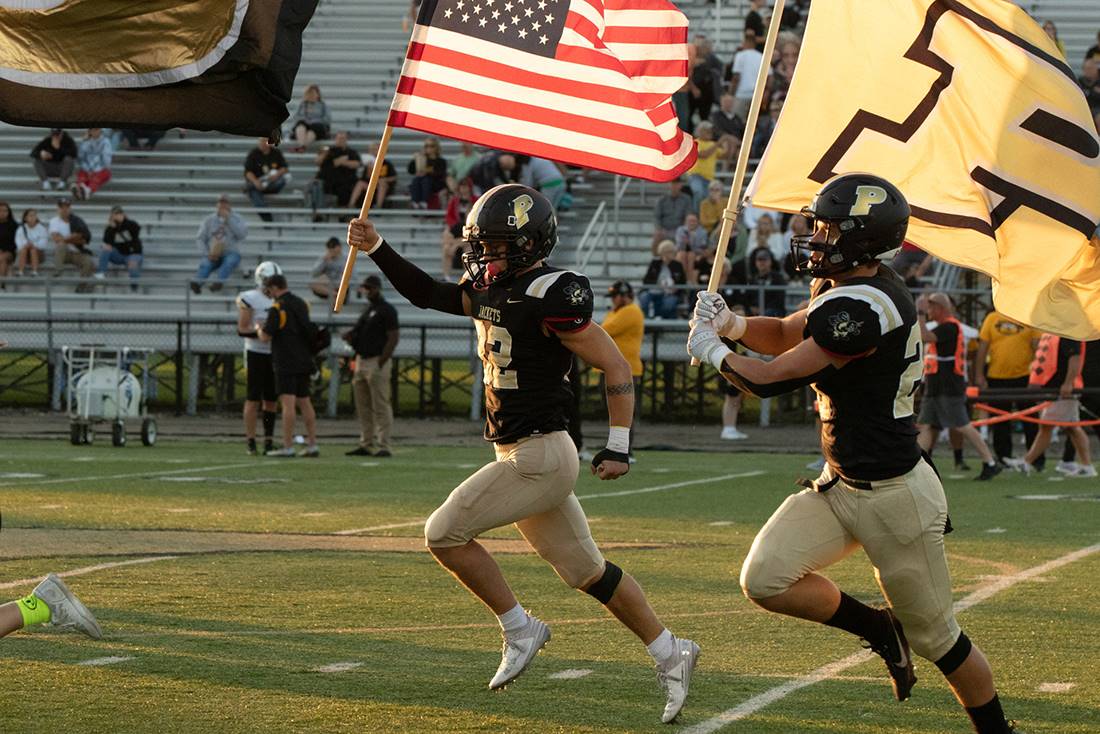two football players running with flags
