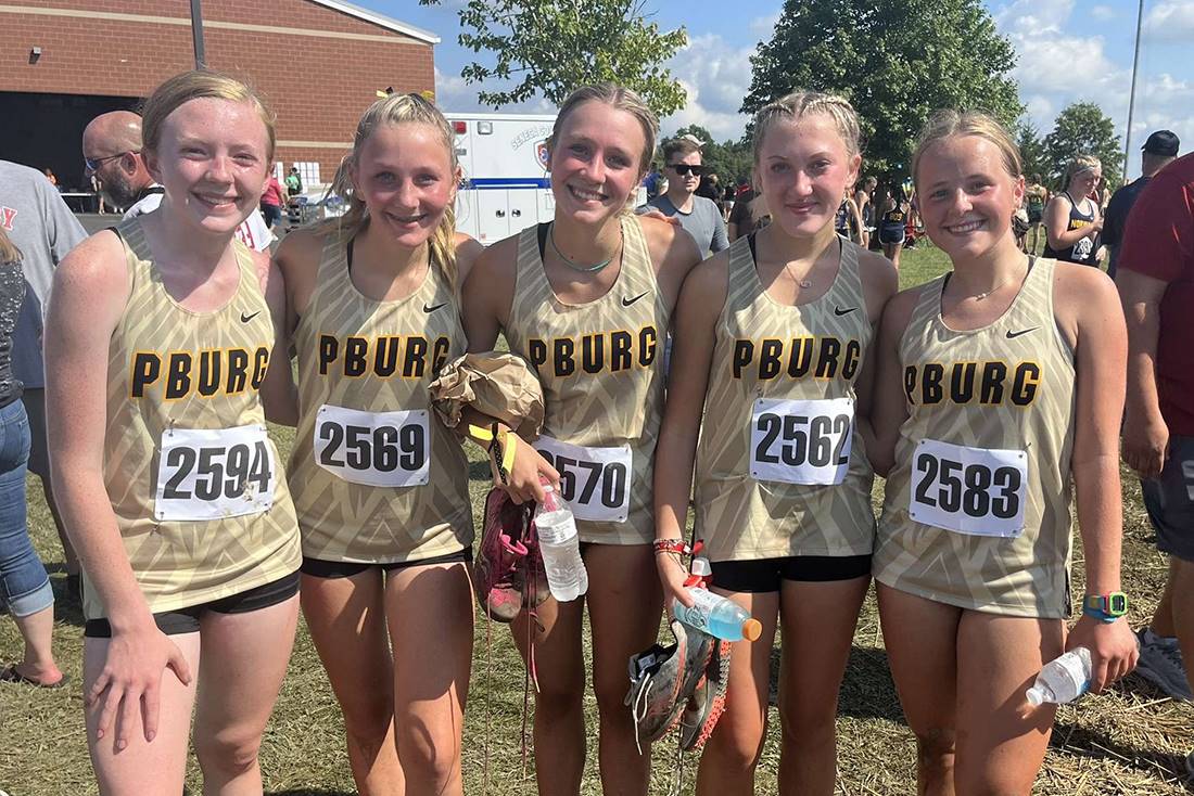 cross country runners posing on field