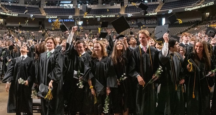 graduates throwing caps in air
