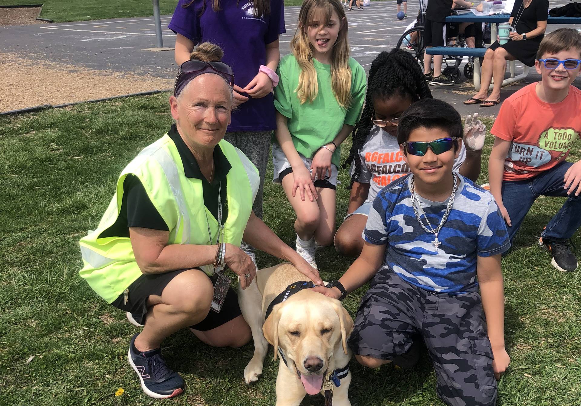 adult with students and dog