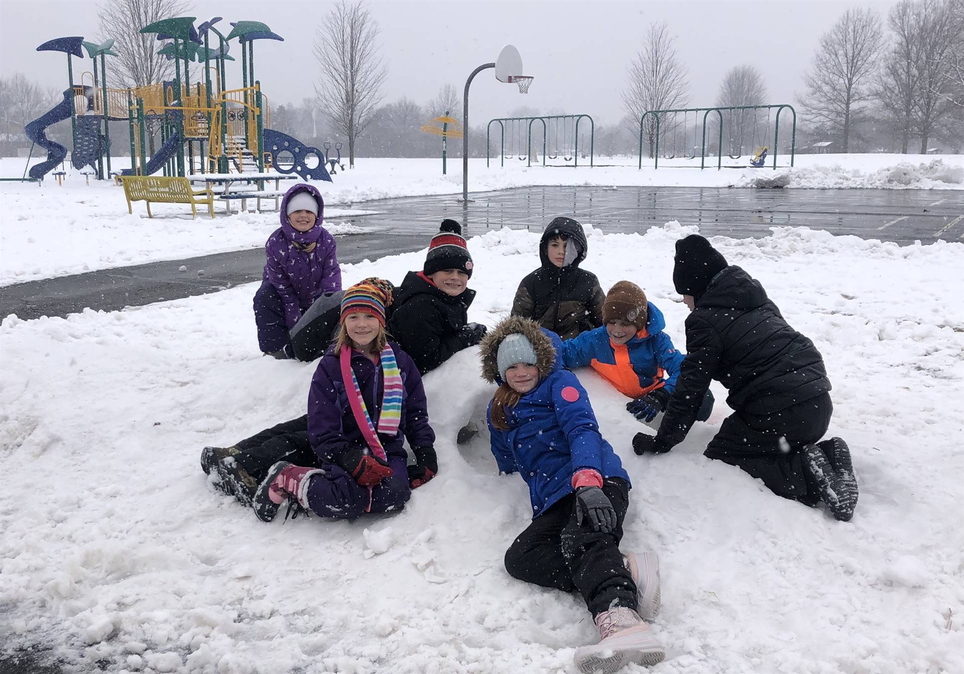 students playing in the snow