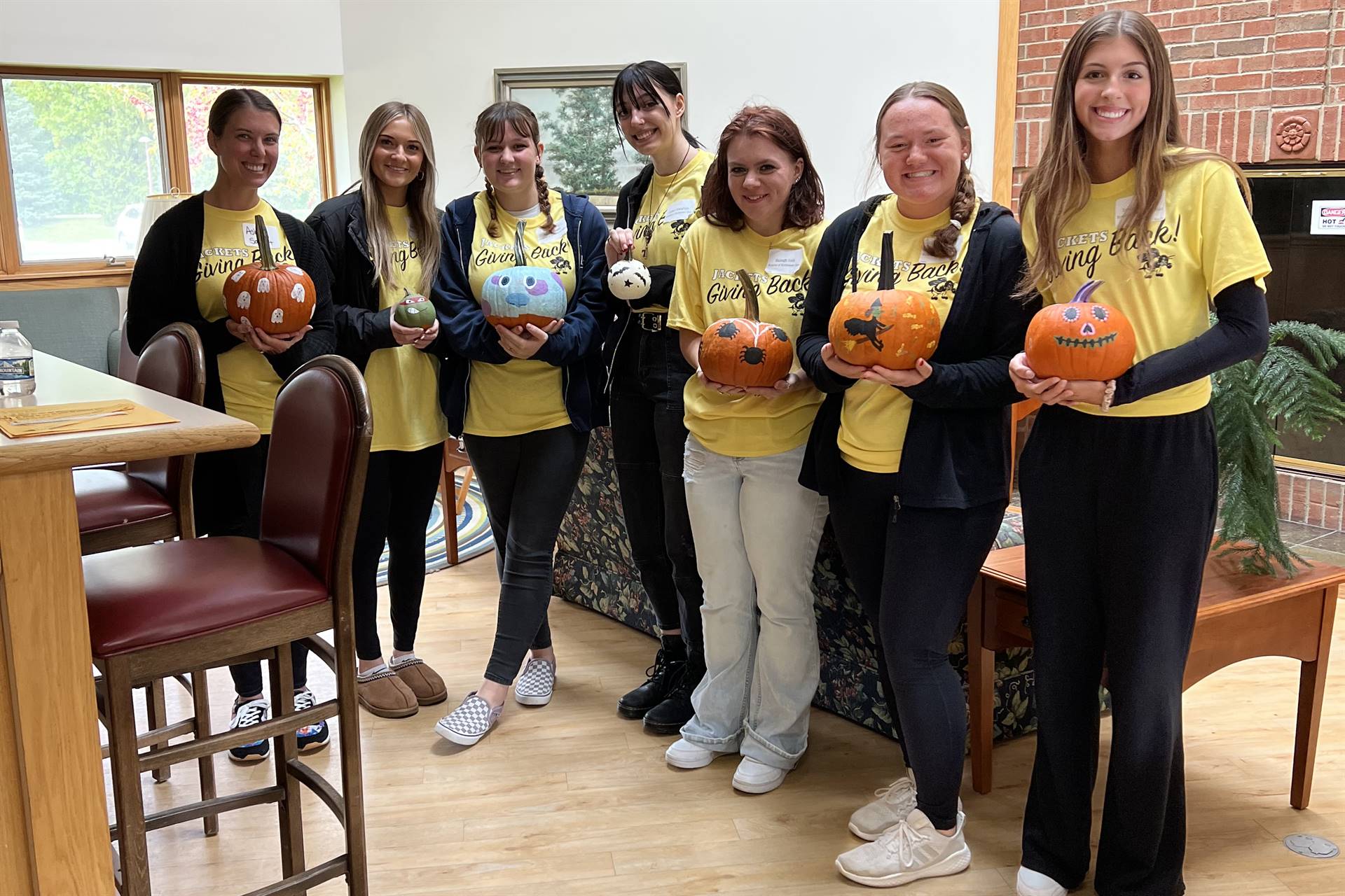 students with decorated pumpkins