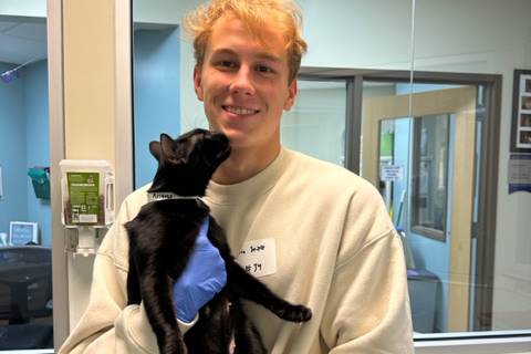 student holding cat